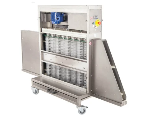 An Universal Tray Cleaning Machine with two rows of empty clear trays set on a conveyor system, featuring stainless steel construction and mounted on wheels.
